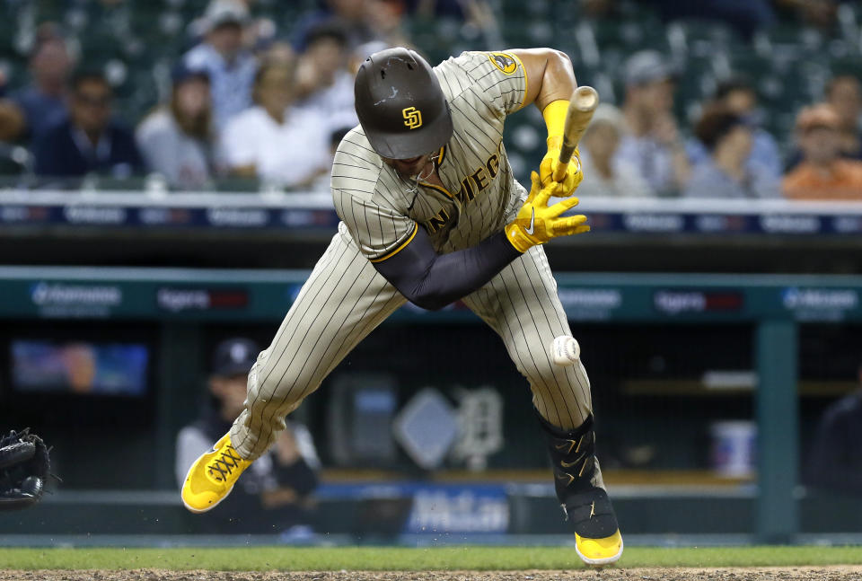 San Diego Padres' Luke Voit get hit by a pitch from Detroit Tigers' Gregory Soto with the bases loaded in the 10th inning to give the padres a 4-3 lead in a baseball game Tuesday, July 26, 2022, in Detroit. (AP Photo/Duane Burleson)