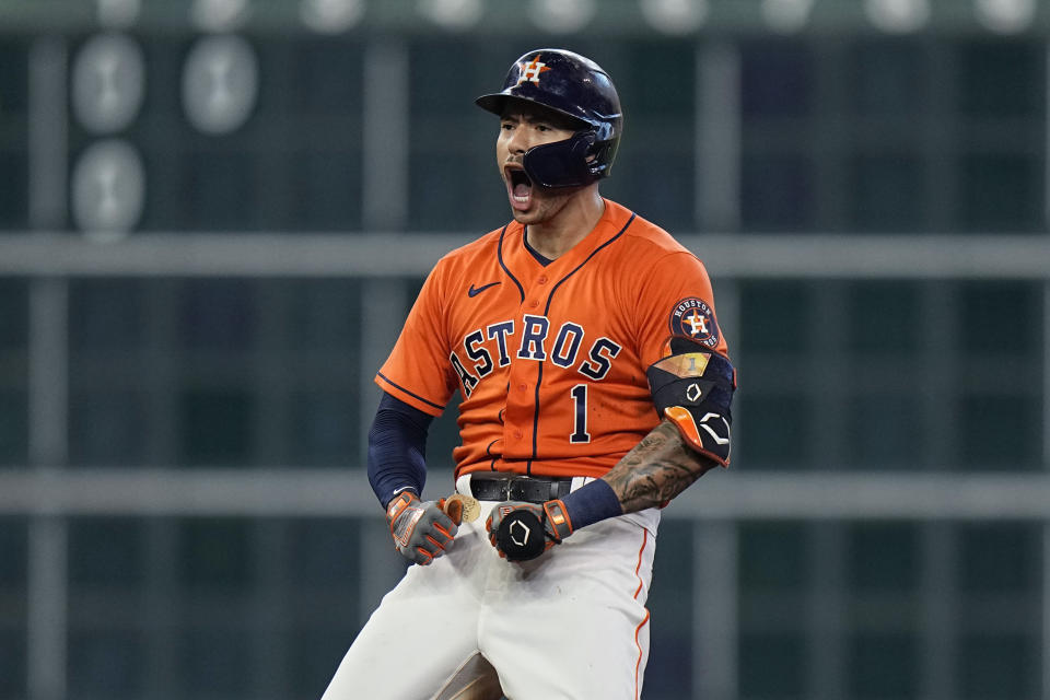 Houston Astros shortstop Carlos Correa (1) celebrates after hitting a two-run double against the Chicago White Sox during the seventh inning in Game 2 of a baseball American League Division Series Friday, Oct. 8, 2021, in Houston. (AP Photo/David J. Phillip)