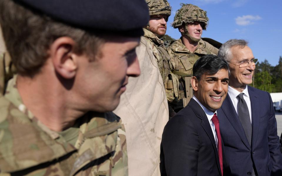 Rishi Sunak and Jens Stoltenberg with British soldiers in Warsaw