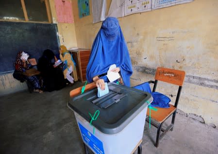 An Afghan woman casts her vote in the presidential election in Jalalabad, Afghanistan
