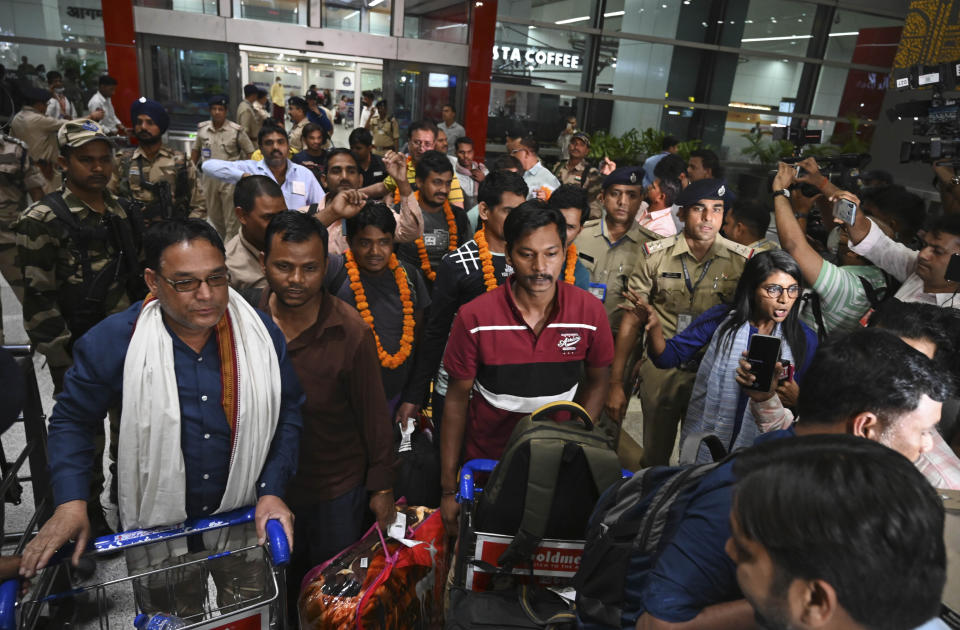 Indians evacuated from Sudan arrive on a flight at the Indira Gandhi International Airport in New Delhi, India, Wednesday, April 26, 2023. (AP Photo)