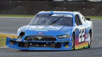 Austin Cindric (22) drives through a turn with damage to his front fender after he was involved in a crash during the NASCAR Xfinity Series road course auto race at Daytona International Speedway, Saturday, Feb. 20, 2021, in Daytona Beach, Fla. (AP Photo/John Raoux)