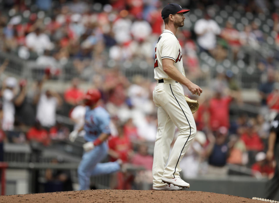 Atlanta Braves pitcher Josh Tomlin, right, turns away as St. Louis Cardinals' Paul Goldschmidt runs the bases after hitting a three-run home run in the fifth inning of the first baseball game of a doubleheader on Sunday, June 20, 2021, in Atlanta. (AP Photo/Ben Margot)