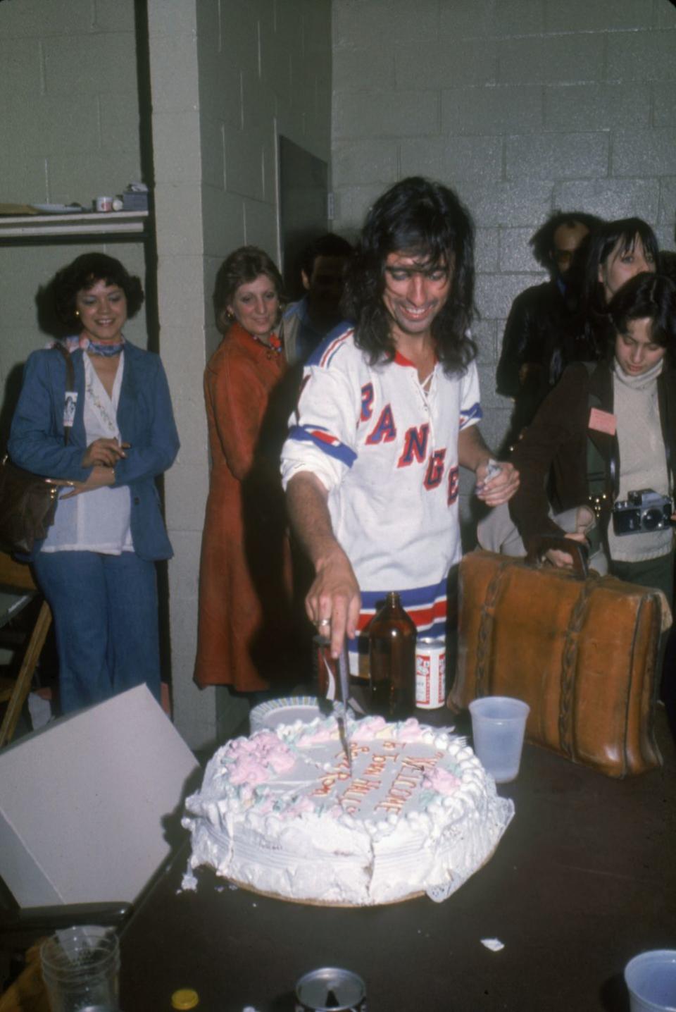 <p>Alice Cooper cuts into a cake backstage at Madison Square Garden after a concert in May, 1975. The rocker was on tour for his 1975 album, <em>Welcome to My Nightmare. </em></p>