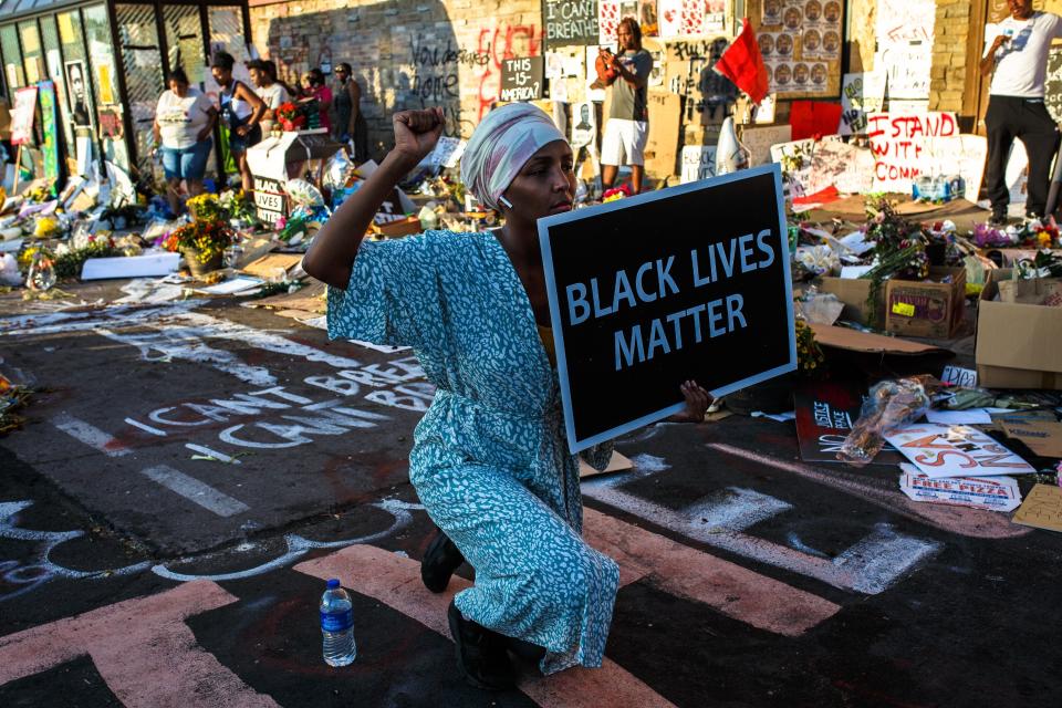 A Somali American protester kneels during a call for justice for George Floyd outside the Cup Foods store, where Floyd was killed, in Minneapolis on June 1. (Photo: KEREM YUCEL via Getty Images)