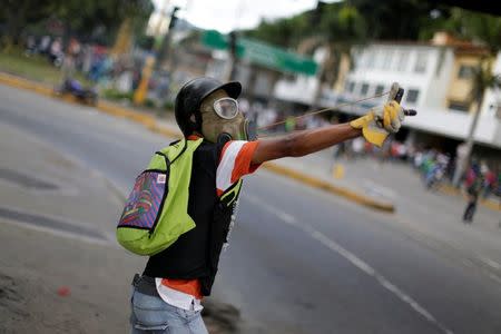 A demonstrator uses a sling shot while clashing with riot security forces during a rally against Venezuela's President Nicolas Maduro's government in Caracas, Venezuela, July 22, 2017. REUTERS/Ueslei Marcelino