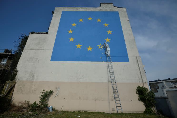 The mural depicts a workman removing a star from the EU flag (Reuters)
