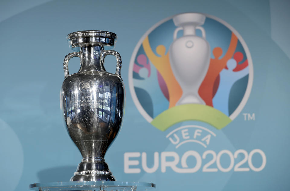 FILE - In this Thursday, Oct. 27, 2016 file photo the Euro soccer championships trophy is seen in front of the logo during the presentation of Munich's logo as one of the host cities of the Euro 2020 European soccer championships in Munich, Germany. UEFA, are set to make a final decision when the UEFA executive committee meets on Tuesday March 17, 2020 after talks with clubs and leagues, about possibly delaying the Euro 2020 soccer tournament by a year as the continent grapples with the outbreak of the coronavirus. (AP Photo/Matthias Schrader, File)