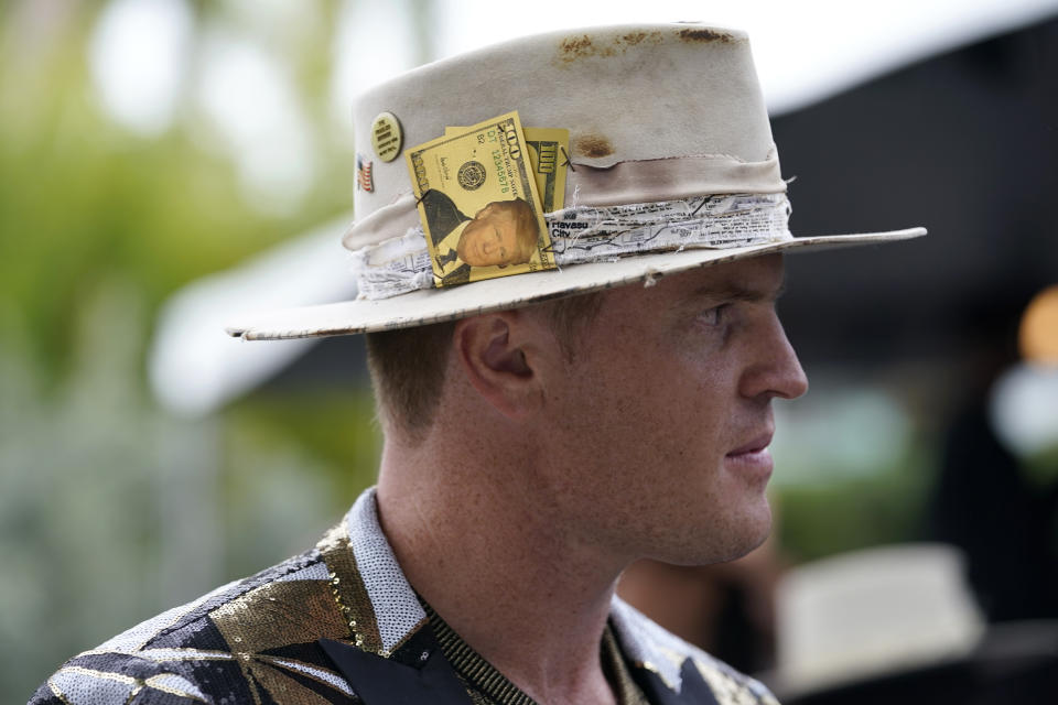 Connor Wade wears a hat with an image of former President Donald Trump as he arrives for the Pegasus World Cup Invitational horse race, Saturday, Jan. 28, 2023, at Gulfstream Park in Hallandale Beach, Fla. (AP Photo/Lynne Sladky)