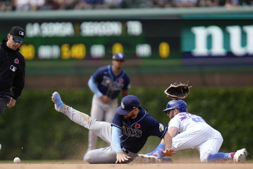 Tampa Bay Rays second baseman Brandon Lowe, second from front right, loses his mitt as Chicago Cubs' Miles Mastrobuoni, right, steals second during the ninth inning of a baseball game Monday, May 29, 2023, in Chicago. (AP Photo/Erin Hooley)