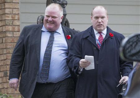 Toronto Mayor Rob Ford leaves his mother's house with his Chief of Staff Earl Provost (R) in Toronto, November 1, 2013. REUTERS/Mark Blinch