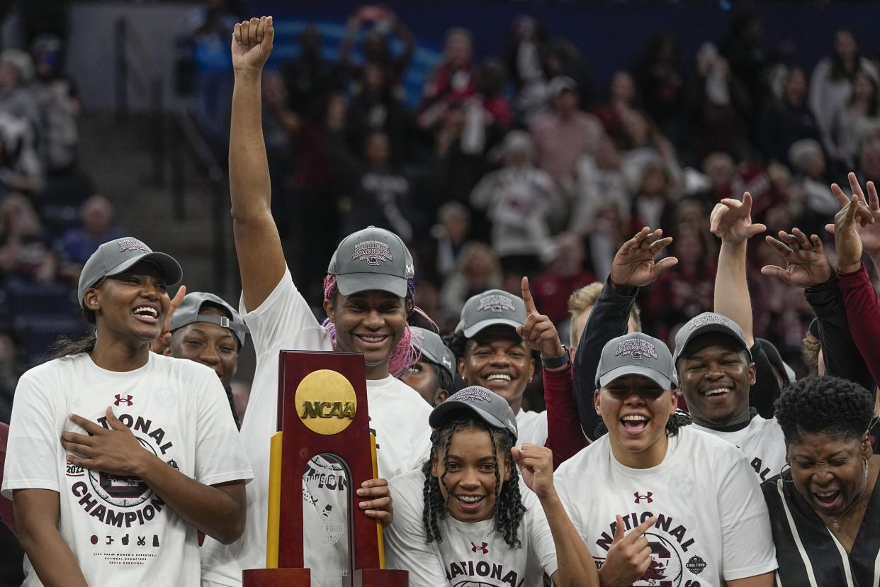 South Carolina's Aliyah Boston and teammates pose with the trophy after winning the 2022 NCAA women's basketball national championship. (AP Photo/Eric Gay)