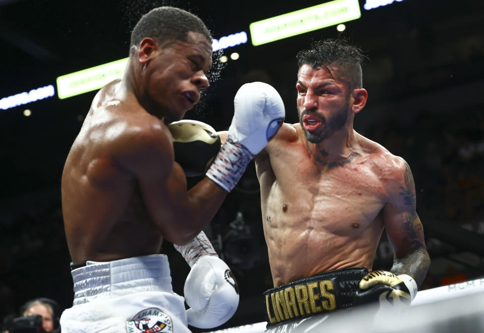 Jorge Linares, right, punches Devin Haney during the WBC lightweight title boxing match Saturday, May 29, 2021, in Las Vegas. (AP Photo/Chase Stevens)