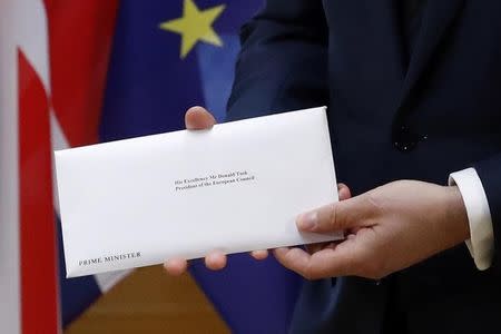 A detail shows EU Council President Donald Tusk who holds British Prime Minister Theresa May's Brexit letter which was delivered by Britain's permanent representative to the European Union Tim Barrow (not pictured) that gives notice of the UK's intention to leave the bloc under Article 50 of the EU's Lisbon Treaty in Brussels, Belgium, March 29, 2017. REUTERS/Yves Herman