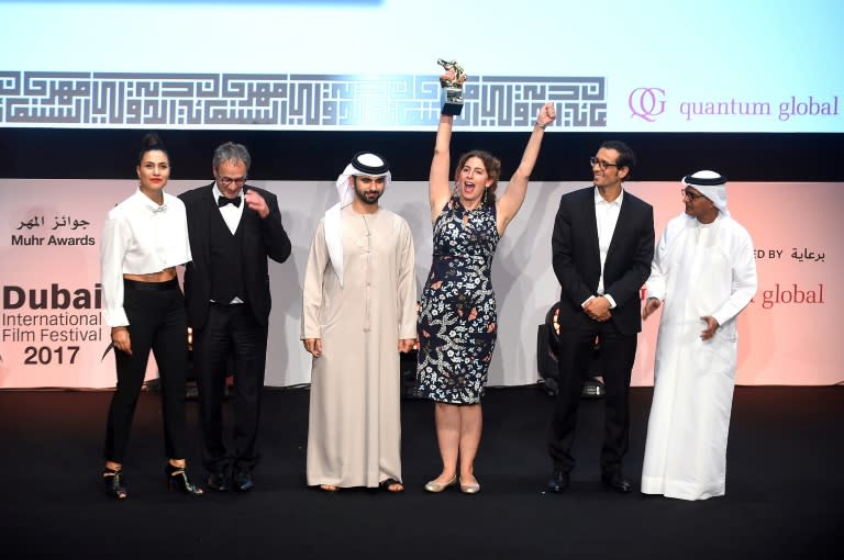 Palestinian Director Annemarie Jacir celebrates after receiving an award for her film "Wajib" during the closing ceremony of the Dubai International Film Festival on December 13, 2017