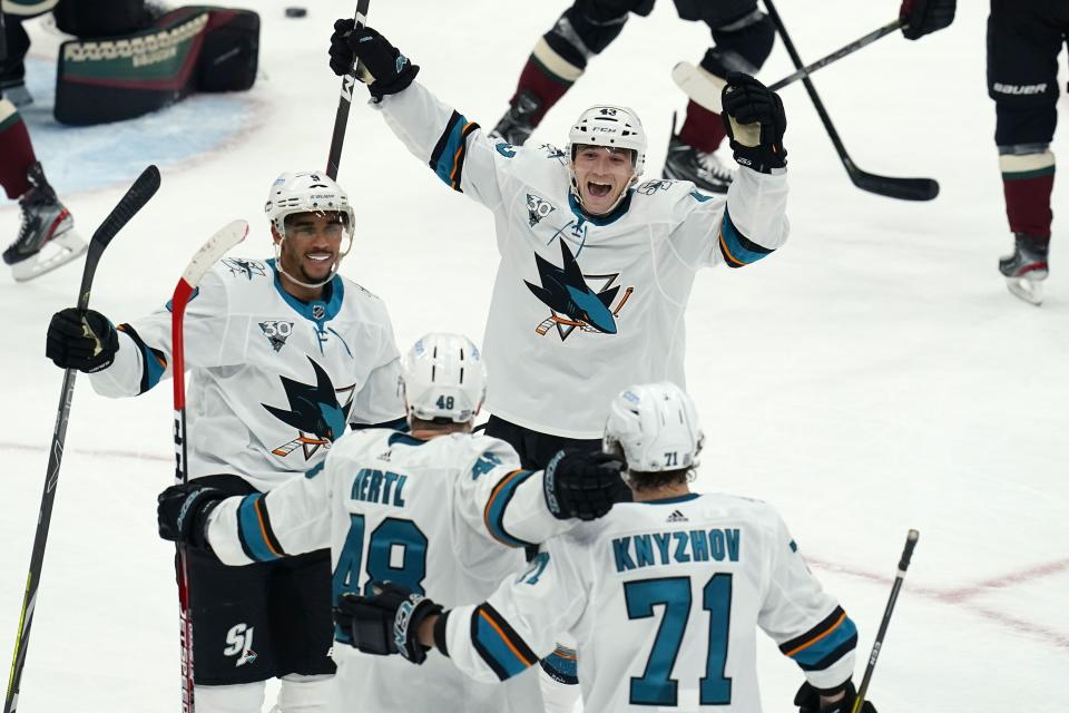 San Jose Sharks center Tomas Hertl (48) celebrates his goal against the Arizona Coyotes with Sharks left wing Evander Kane (9), left wing John Leonard (43) and defenseman Nikolai Knyzhov (71) during the first period of an NHL hockey game Thursday, Jan. 14, 2021, in Glendale, Ariz. (AP Photo/Ross D. Franklin)