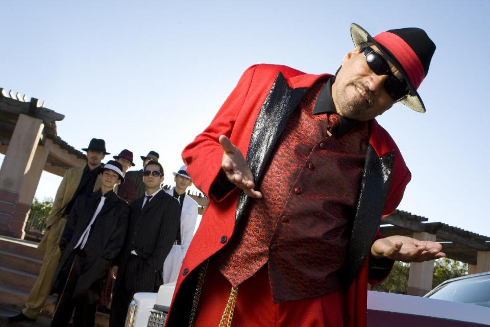 FILE - In this Nov. 15, 2008 file photo, Houston's Pancho Claus, Richard Reyes, poses with his helpers at Guadalupe Plaza on Houston's east side. (AP Photo/Houston Chronicle, Nick de la Torre, File) MANDATORY CREDIT