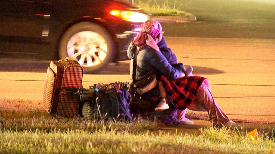 A passenger waits outside the Greyhound Bus terminal after a man died from a shooting on North Wilson Road. (NBC4/Ronald Clark)