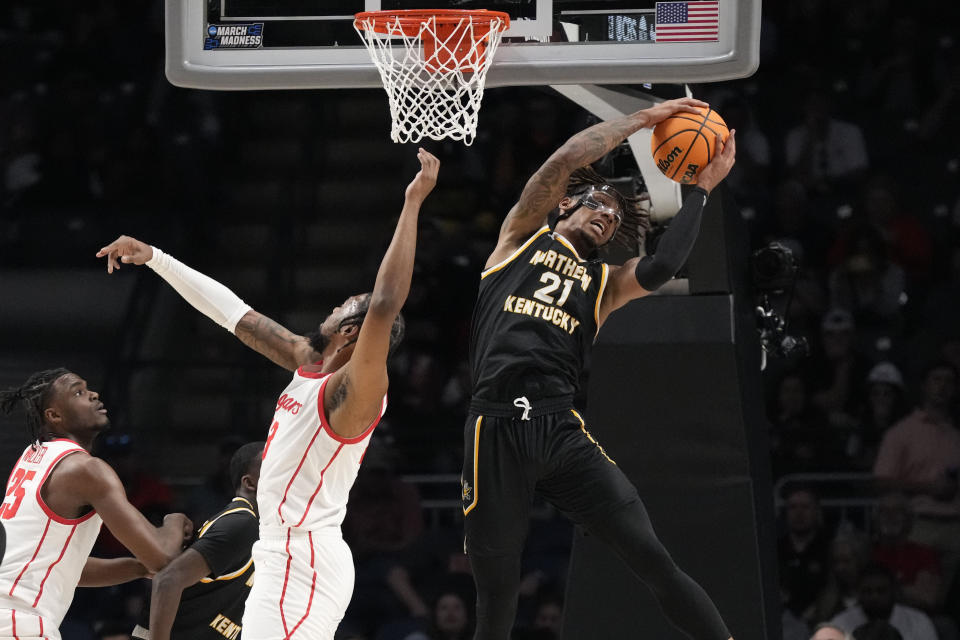 Northern Kentucky forward Chris Brandon (21) pulls down a rebound next to Houston defenders during the first half of a first-round college basketball game in the men's NCAA Tournament in Birmingham, Ala., Thursday, March 16, 2023. (AP Photo/Rogelio V. Solis)