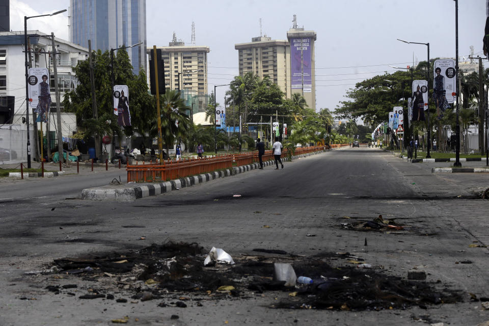 An empty street following curfew imposed by the government in Lagos, Nigeria, Thursday Oct. 22, 2020. Lagos streets were empty and shops were shuttered Thursday, as residents of Nigeria's largest city obeyed the government's curfew, stopping the protests against police brutality that had lasted for two weeks. ( AP Photo/Sunday Alamba)