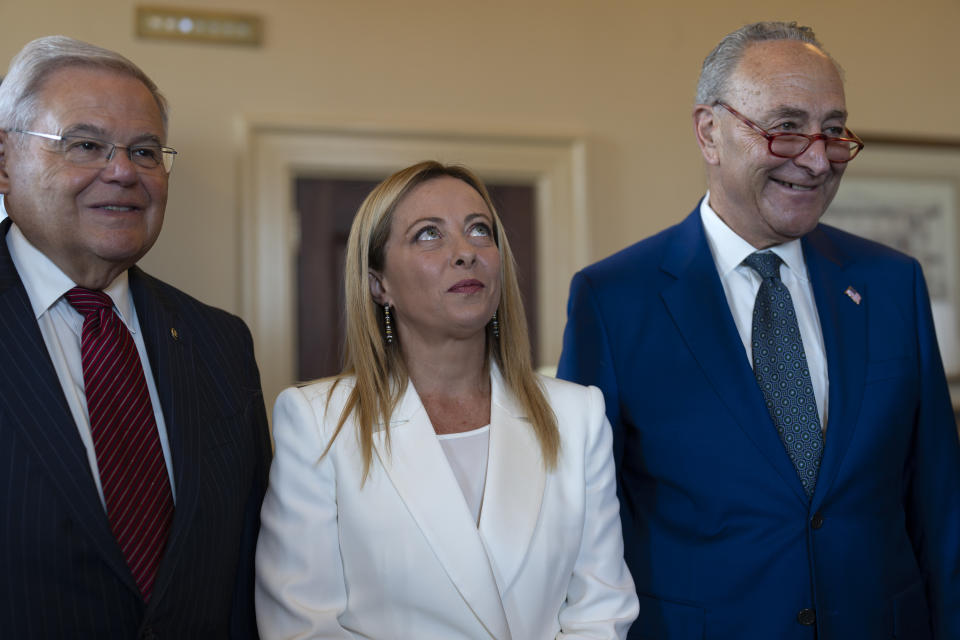 Italian Prime Minister Giorgia Meloni, center, is welcomed by Senate Foreign Relations Committee Chair Bob Menendez, D-N.J., and Senate Majority Leader Chuck Schumer, D-N.Y., right, before a luncheon meeting at the Capitol in Washington, Thursday, July 27, 2023. (AP Photo/J. Scott Applewhite)