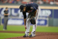 Atlanta Braves starting pitcher Charlie Morton rubs his leg before leaving the game during the third inning of Game 1 in baseball's World Series between the Houston Astros and the Atlanta Braves Tuesday, Oct. 26, 2021, in Houston. (AP Photo/Ashley Landis)