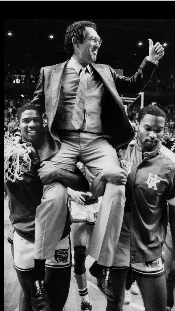 Richard Madison and Winston Bennett gave University of Kentucky coach Eddie Sutton a victory ride after his first UK team defeated Alabama for the SEC Tournament title. Mar 8 1986