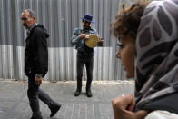 A street musician plays music at the old main bazaar in Tehran, Iran, Tuesday, April 16, 2024. Israel says it is poised to retaliate against Iran, risking further expanding the shadow war between the two foes into a direct conflict after an Iranian attack over the weekend sent hundreds of munitions into Israeli airspace. (AP Photo/Vahid Salemi)