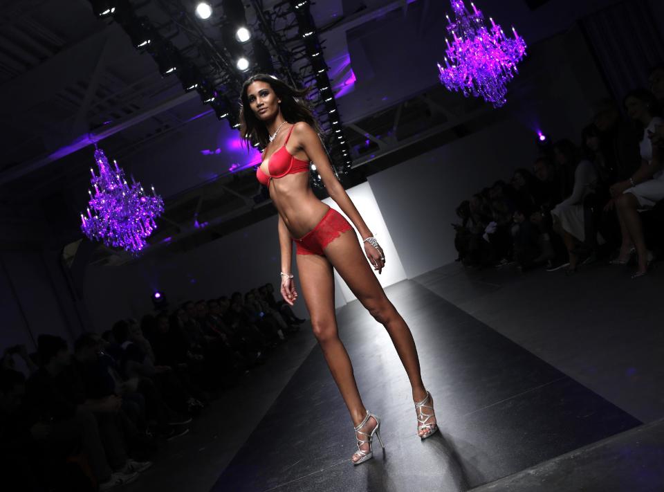 CAPTION CORRECTION, CORRECTS TO REMOVE REFERENCE TO ANNA SUI, WHOSE COLLECTION WAS NOT REPRESENTED AT THIS SHOW - A model pauses on the runway during the presentation of the GS Shop Lingerie show featuring Spanx, Wonderbra, and Platex during Fashion Week Tuesday, Feb. 4, 2014, in New York. (AP Photo/Kathy Willens)