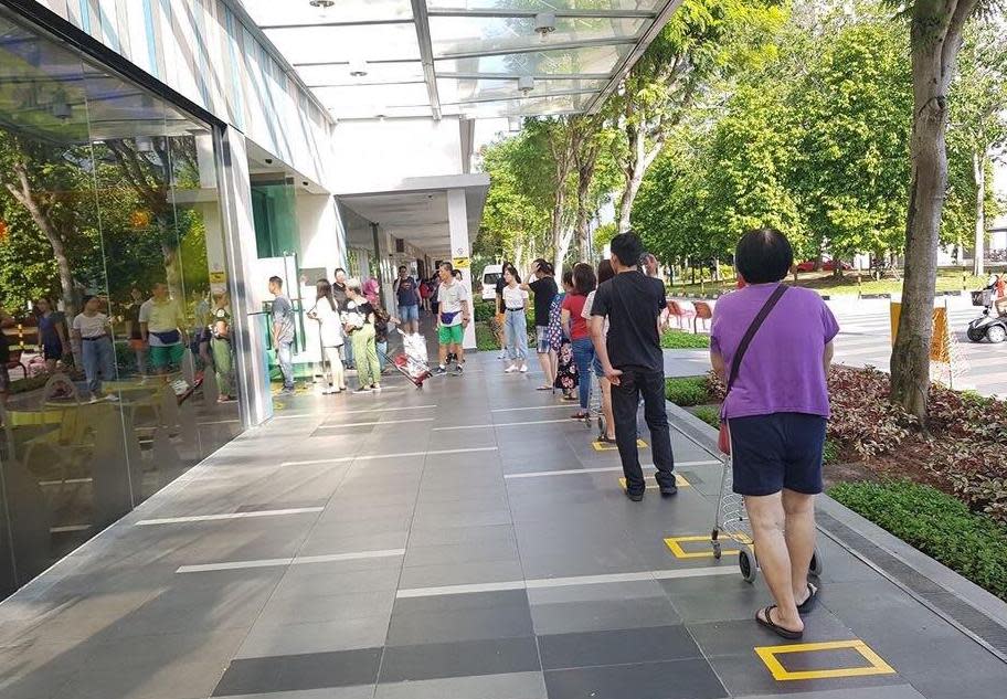 Demarcated squares for patrons to stand in queue for entry into YewTee Point on 27 March, 2020. (PHOTO: Arvie Castro)