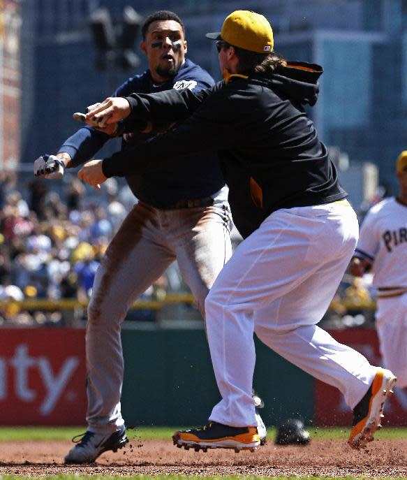 Pittsburgh Pirates' Travis Snider, right, takes down Milwaukee Brewers' Carlos Gomez during a skirmish between the teams during the third inning of a baseball game in Pittsburgh, Sunday, April 20, 2014. Gomez and Snider were ejected from the game. (AP Photo/Gene J. Puskar)