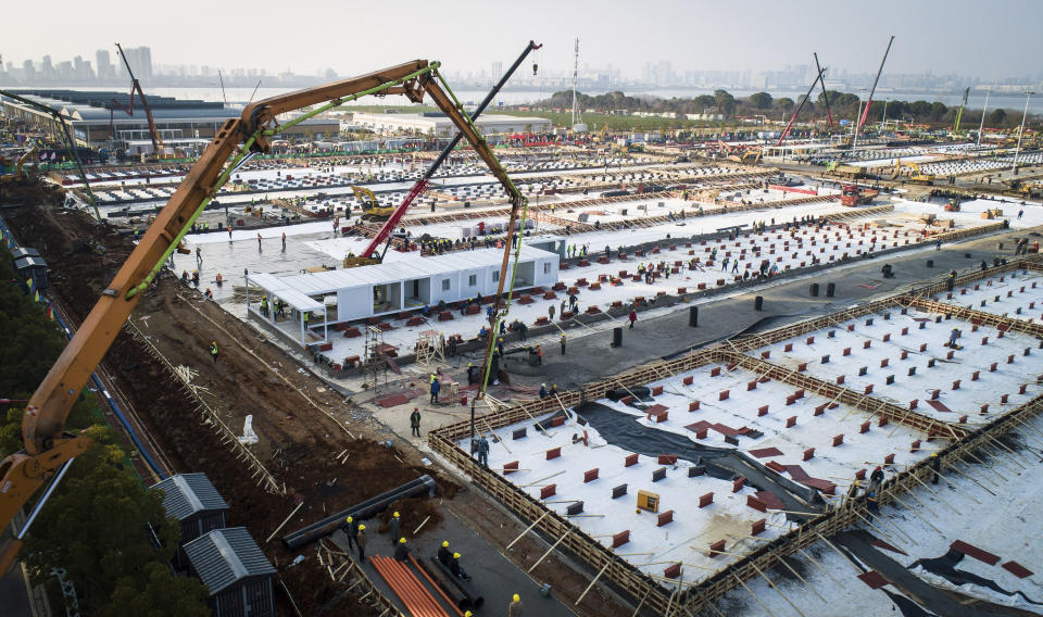 FILE - This Jan. 30, 2020, file photo released by China's Xinhua News Agency, shows construction workers at the site of the Leishenshan temporary field hospital being built in Wuhan in central China's Hubei Province. The Chinese city of Wuhan is looking back on a year since it was placed under a 76-day lockdown beginning Jan. 23, 2020. (Xiao Yijiu/Xinhua via AP, File)