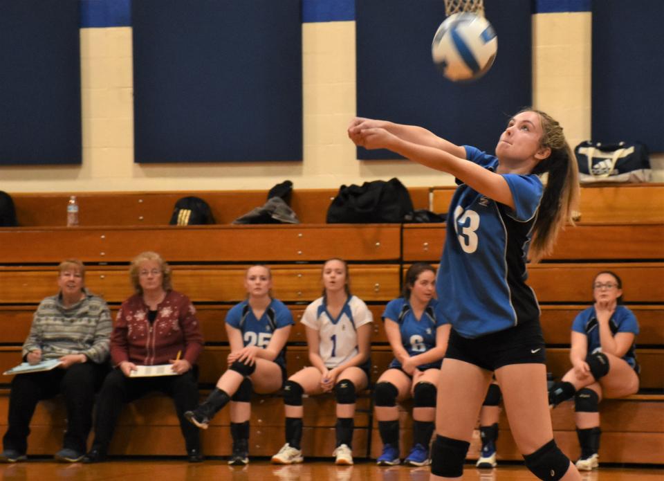 Dolgevile Blue Devil Reece Lamphere passes the ball with her coaches and teammates looking on from the bench during Monday's match against the Herkimer Magicians.