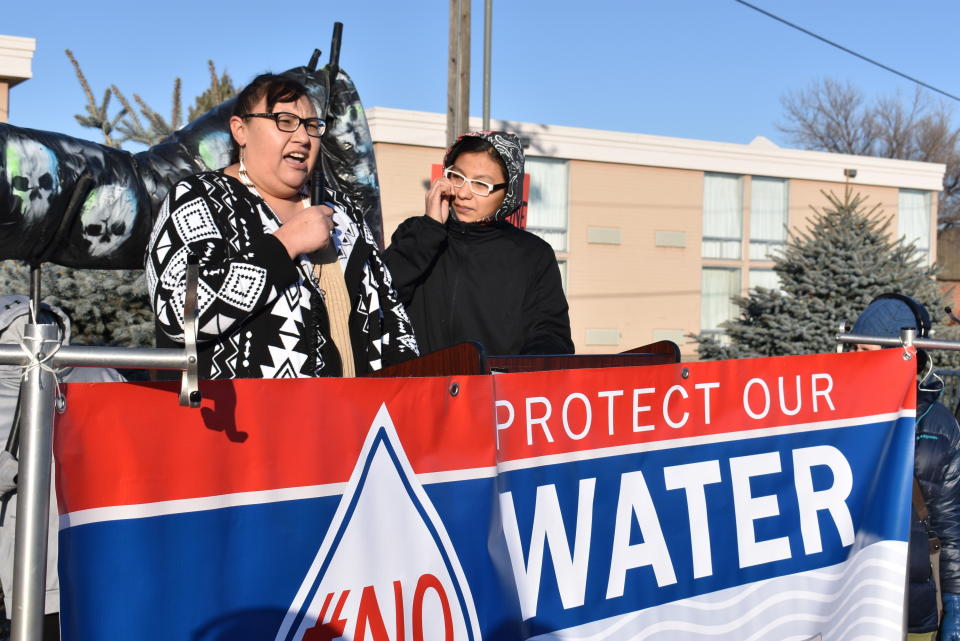 Angeline Cheek, left, a community organizer from the Fort Peck Indian Reservation, speaks about the potential environmental damage from the Keystone XL oil pipeline from Canada during a demonstration in Billings, Mont. on Tuesday, Oct. 29, 2019. (AP Photo/Matthew Brown)