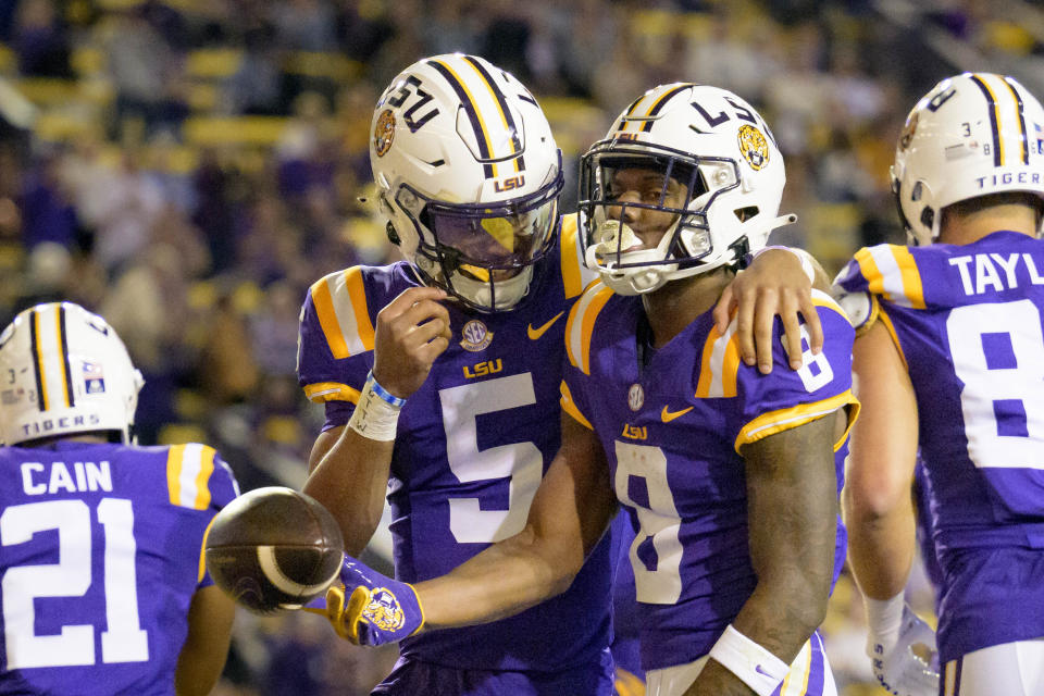 LSU wide receiver Malik Nabers (8) celebrates after his touchdown with quarterback Jayden Daniels (5) during the first half of an NCAA college football game against Georgia State in Baton Rouge, La., Saturday, Nov. 18, 2023. (AP Photo/Matthew Hinton)