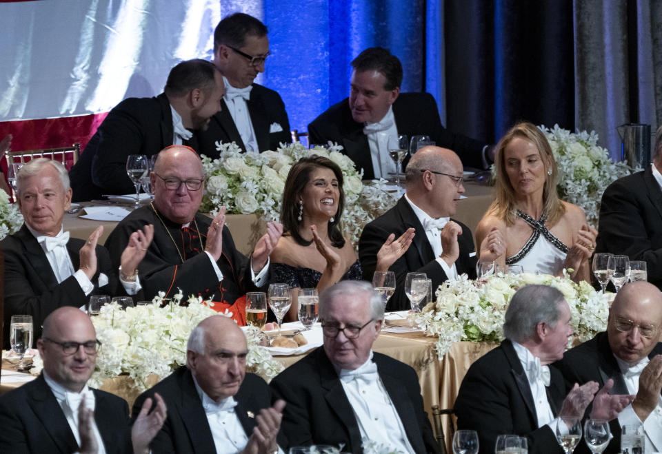 Keynote speaker Ambassador to the United Nations Nikki Haley, center, shares a light moment as she attends the 73rd Annual Alfred E. Smith Memorial Foundation Dinner Thursday, Oct. 18, 2018, in New York. Center left is Archbishop of New York Cardinal Timothy Dolan, and right center is Michael Haley, husband of Nikki Haley. (AP Photo/Craig Ruttle)
