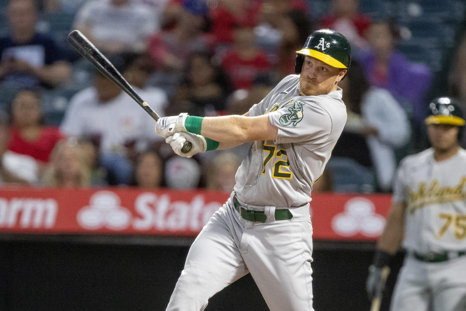 Oakland Athletics' Conner Capel singles to left field to score Tony Kemp during the first inning of a baseball game against the Los Angeles Angels in Anaheim, Calif., Wednesday, Sept. 28, 2022. (AP Photo/Alex Gallardo)