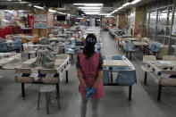 A restaurant employee looks at empty sits at a Chinese food court in Hong Kong, Wednesday, July 29, 2020. Hong Kong has banned dining-in at restaurants completely on Wednesday and make it mandatory to wear masks in all public places, as the city battles its worst coronavirus outbreak to date. (AP Photo/Vincent Yu)