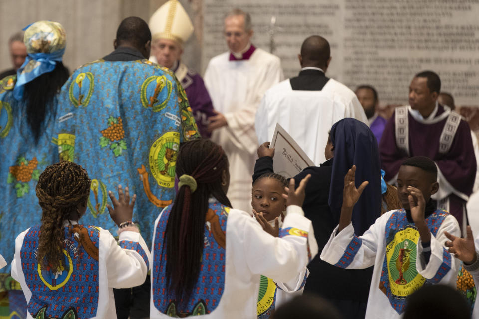 Faithful dance and sing in front of Pope Francis as he celebrates a Mass for the Congolese Catholic community of Rome in St. Peter's Basilica at the Vatican Sunday, Dec. 1, 2019. (AP Photo/Alessandra Tarantino)