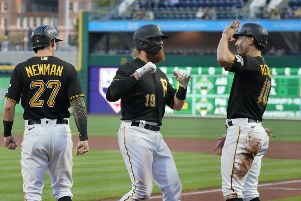 Pittsburgh Pirates' Colin Moran (19) is greeted by Bryan Reynolds (10) and Kevin Newman after hitting a three-run home run off Chicago Cubs starting pitcher Alec Mills in the first inning of a baseball game in Pittsburgh, Tuesday, Sept. 28, 2021. (AP Photo/Gene J. Puskar)