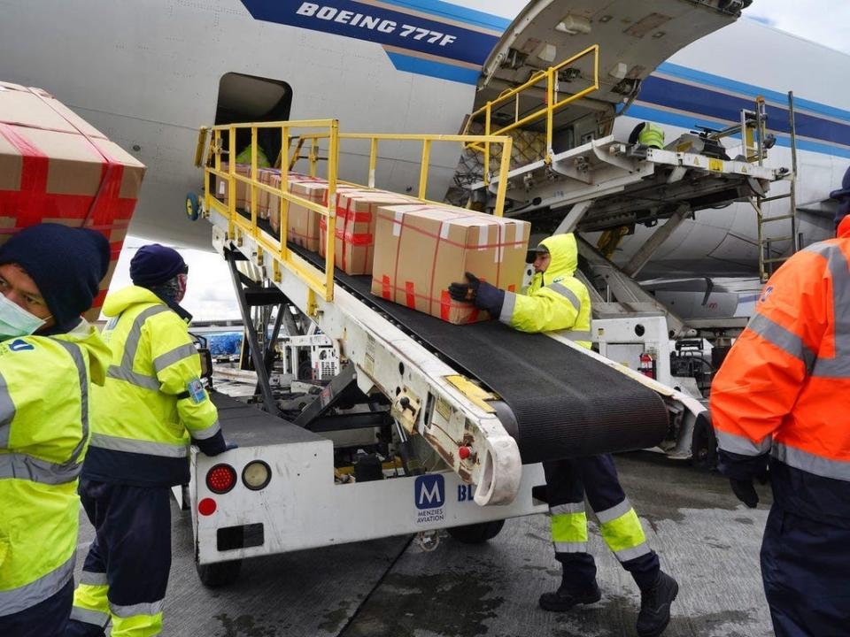 Workers load cargo onto a Boeing 777F.