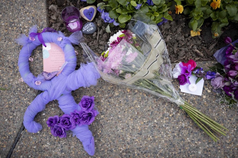 During the fifth anniversary observance of Prince's death, fans left flowers, candles and wreaths to commemorate the legendary musician and artist outside of Paisley Park, Wednesday, April 21, 2021, in Chanhassen, Minn. Prince fans were invited, 20 at a time, to pay their respects at the museum complex. (AP Photo/Stacy Bengs)