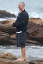 <p>Christian Bale takes a stroll along the beach on a rainy day in Sydney, Australia on Thursday.</p>