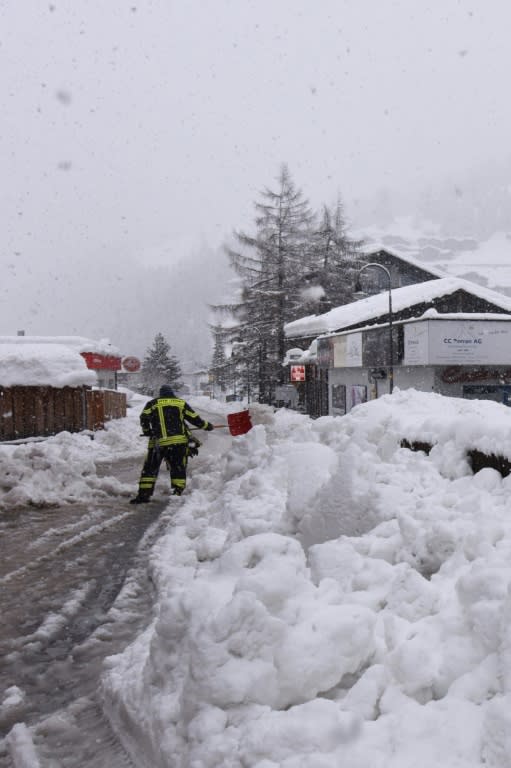 Workers worked to clear the snow as thousands of tourists were stranded in Zermatt