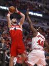 Washington Wizards center Marcin Gortat (4) shoots over Chicago Bulls center Nazr Mohammed (48) during the first half of Game 2 in an opening-round NBA basketball playoff series Tuesday, April 22, 2014, in Chicago. (AP Photo/Charles Rex Arbogast)