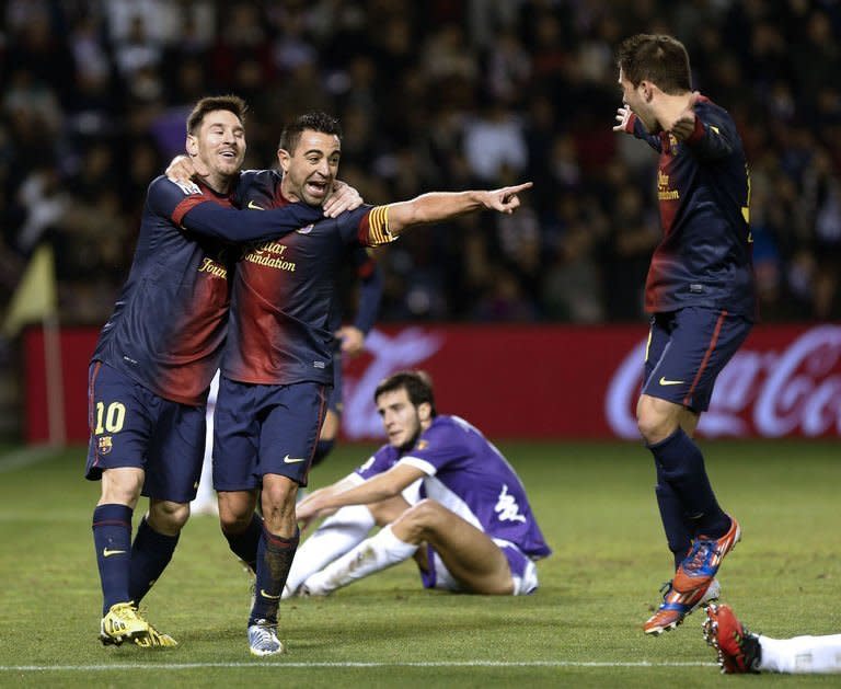 Barcelona's midfielder Xavi Hernandez (C) celebrates with forward Lionel Messi (L) and Jordi Alba after scoring during the Spanish league football match Valladolid vs FC Barcelona at the Jose Zorilla stadium in Valladolid on December 22, 2012. Barcelona won 3-1