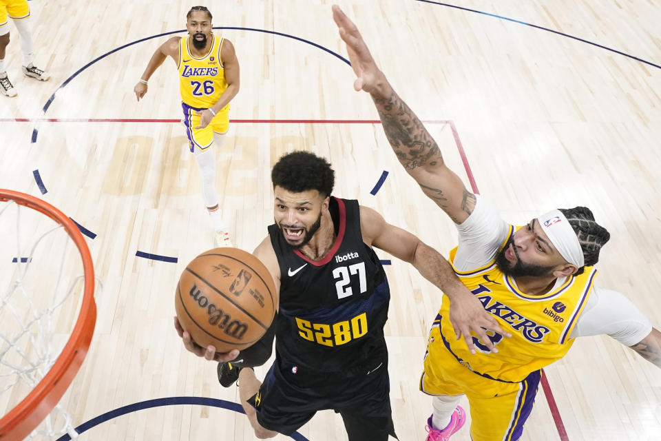 Denver Nuggets guard Jamal Murray (27) goes up for a shot against Los Angeles Lakers forward Anthony Davis (3) during the second half in Game 2 of an NBA basketball first-round playoff series, Monday, April 22, 2024, in Denver. (AP Photo/Jack Dempsey)