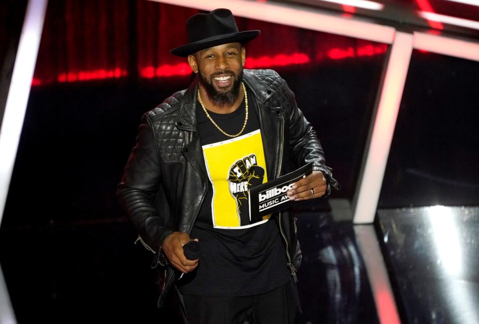 Stephen "tWitch" Boss presents the award for top Latin artist at the 2020 Billboard Music Awards.