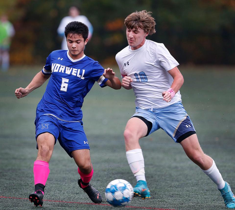 Norwell #6 Zach Bello and EB #10 Mathias Floeck fight for the ball near the Norwell net. Norwell boys soccer hosted East Bridgewater onMonday October 17, 2022.