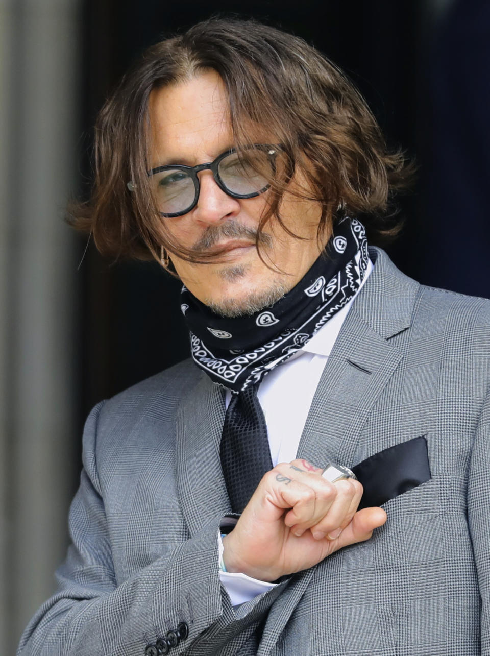 Actor Johnny Depp arrives at the High Court in London to give evidence in his libel case against the publishers of The Sun and its executive editor, Dan Wootton, in London, Monday July 13, 2020. Depp is expected to wrap up his evidence at his libel trial against a tabloid newspaper that accused him of abusing ex-wife Amber Heard. The Hollywood star is suing News Group Newspapers, publisher of The Sun, and the paper’s executive editor, Dan Wootton, over an April 2018 article that called him a “wife-beater.” (Aaron Chown/PA via AP)